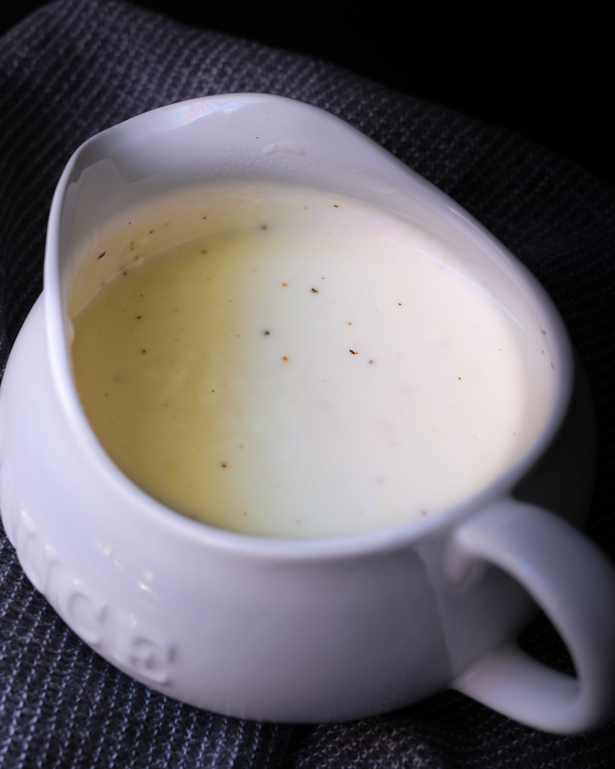 overhead look at a saucier full of white sauce.