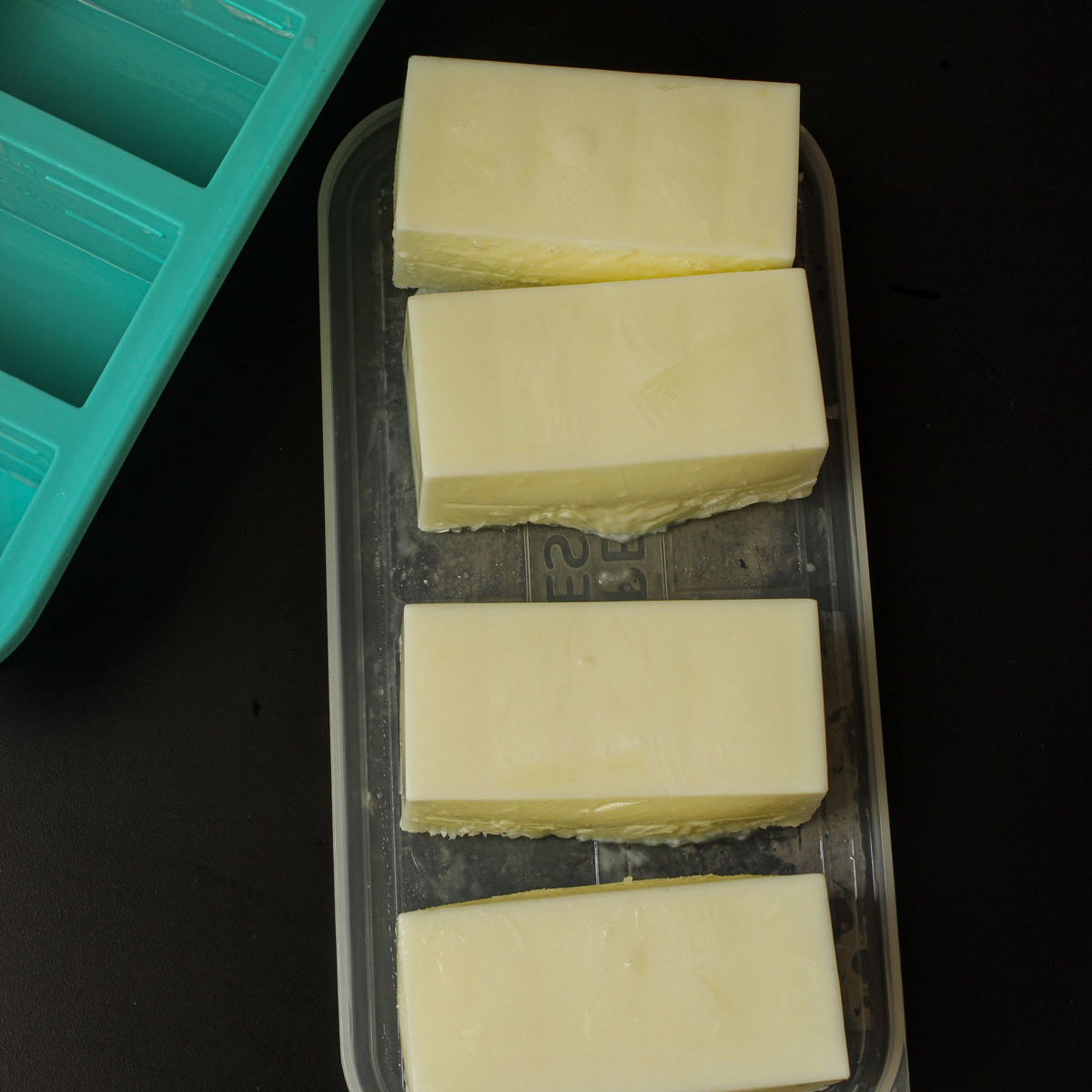 frozen soupercubes of buttermilk on the lid next to the mold.