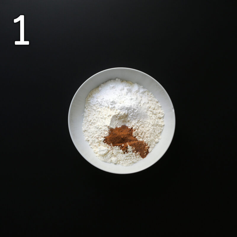 dry ingredients added to a white mixing bowl.