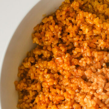 closeup of Spanish brown rice in white bowl.