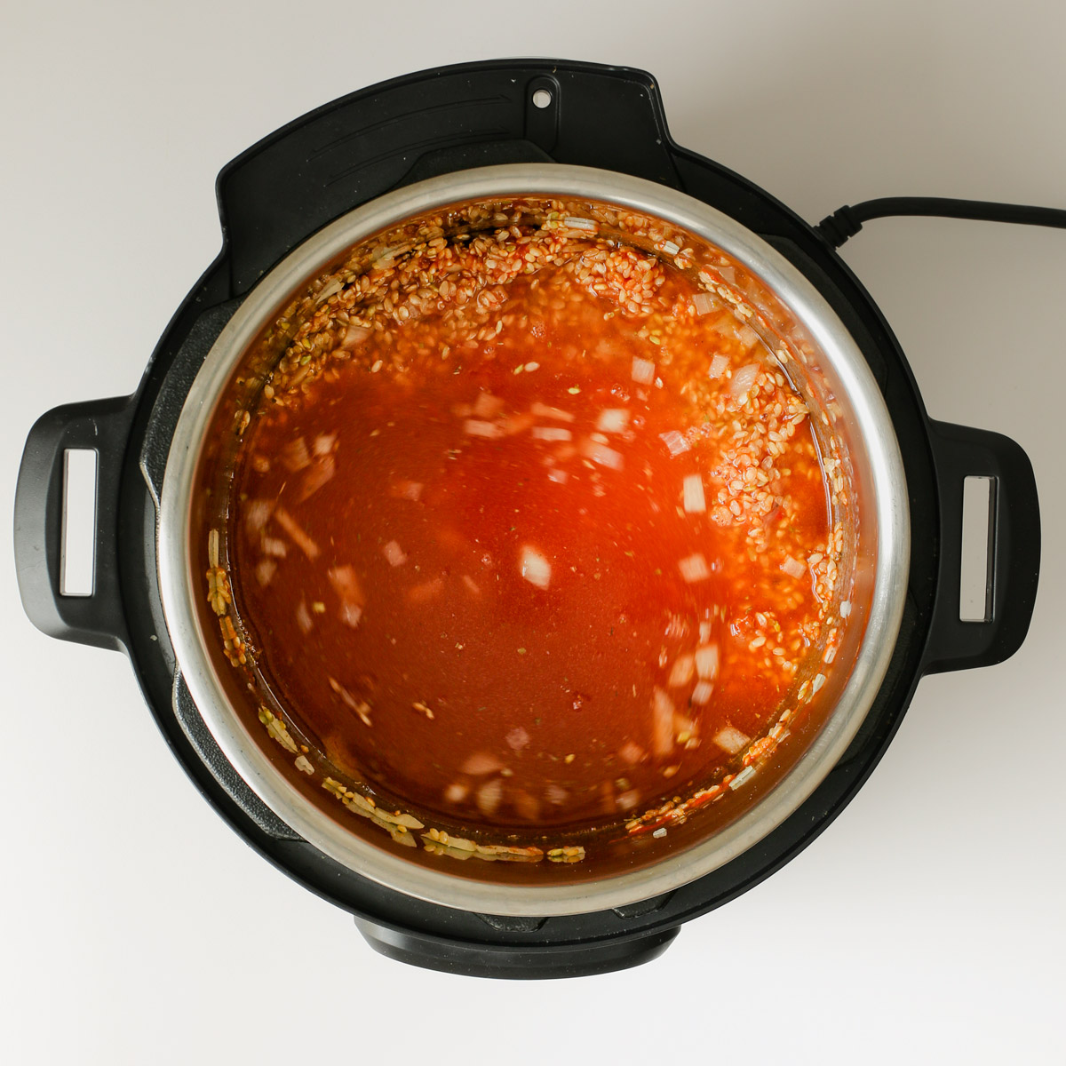 adding broth added to instant pot.